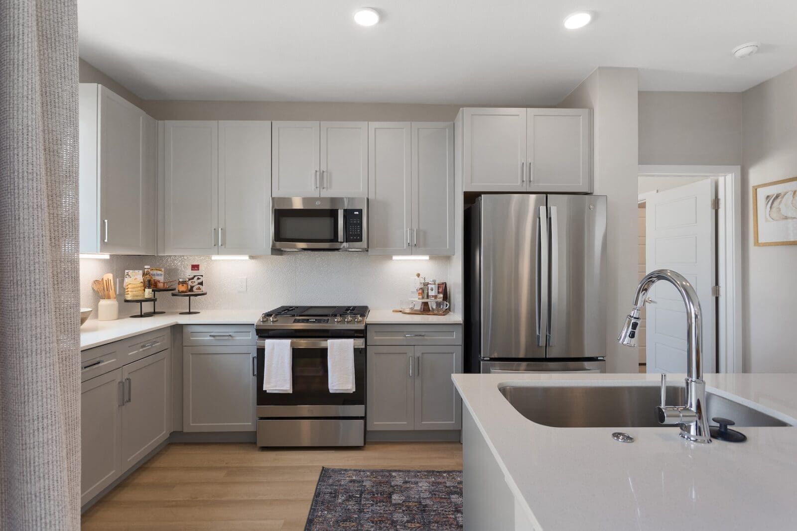 Modern kitchen with stainless steel appliances, ample cabinet space, and quartz countertops at Echo Biltmore in Phoenix AZ.
