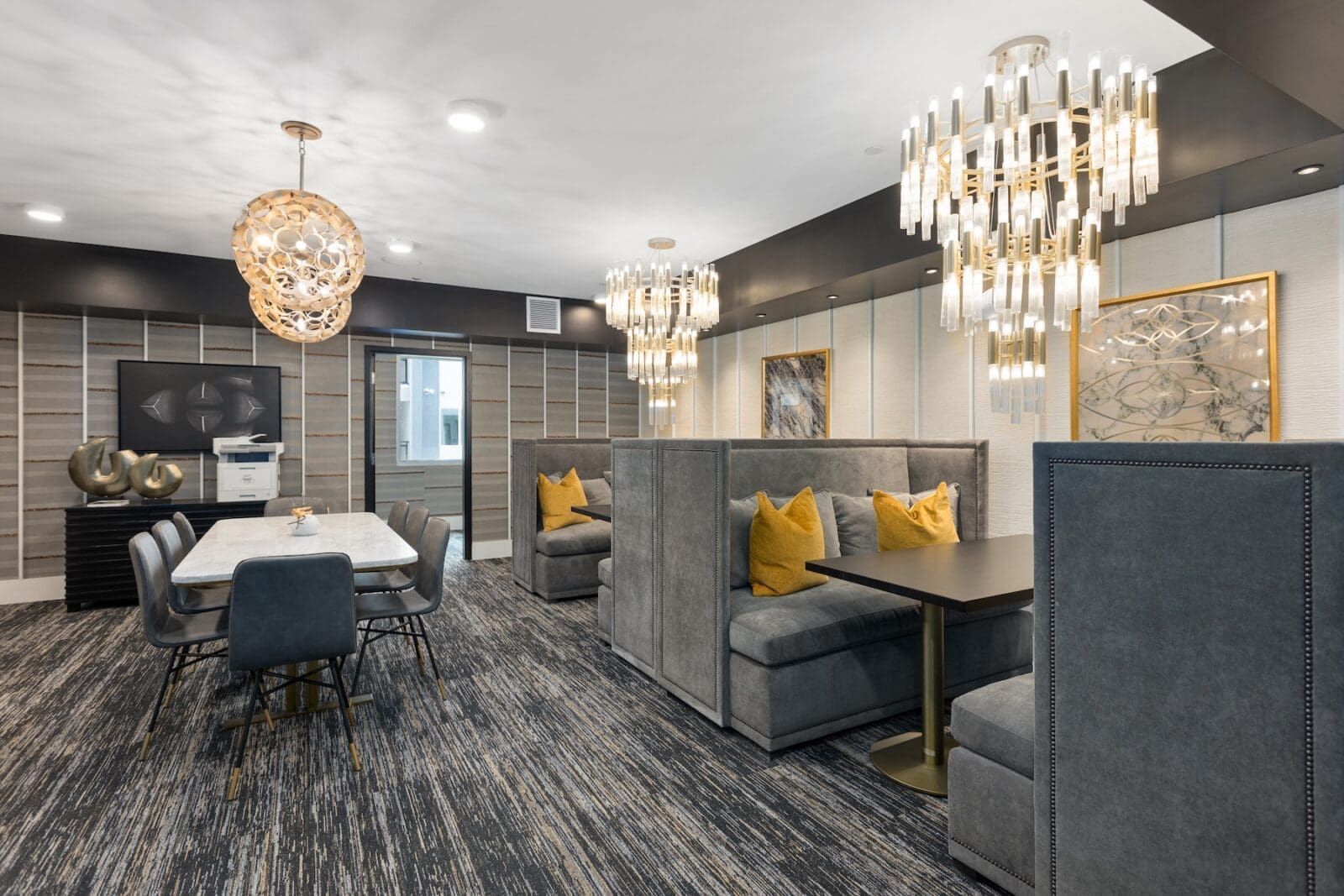Luxurious lounge area with plush seating, elegant chandeliers, and modern decor at Echo Biltmore in Phoenix AZ.