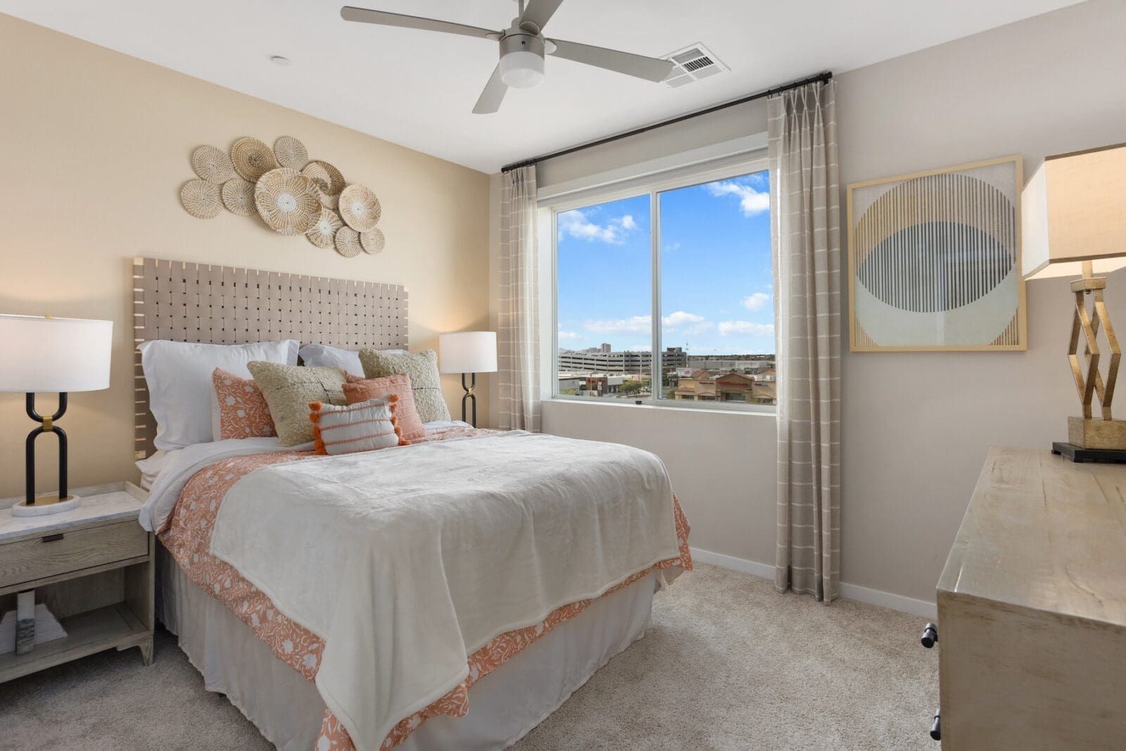 Bedroom with bed, nightstands, window, and decor in neutral colors.