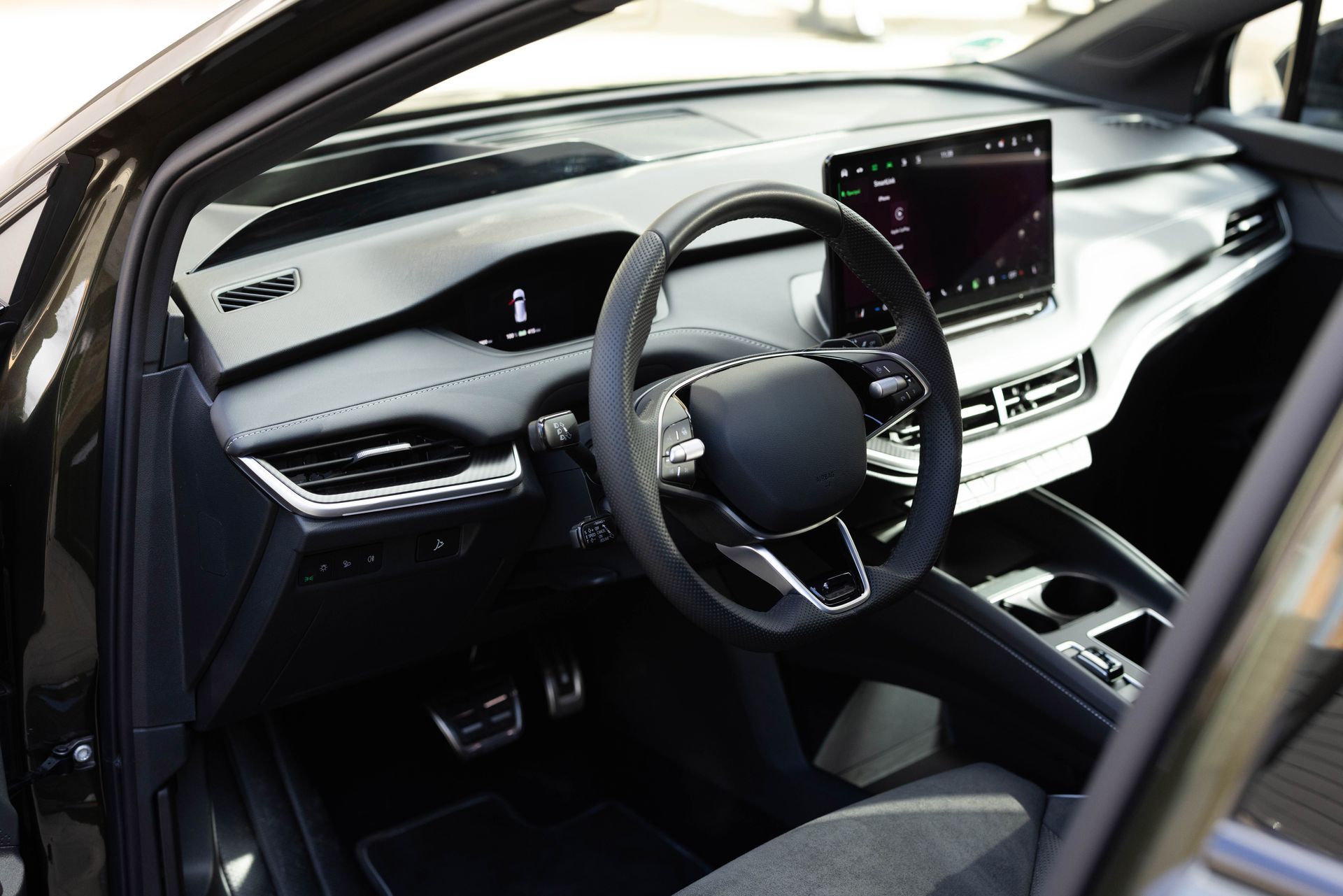 Modern car interior with steering wheel, digital dashboard, and center touchscreen display
