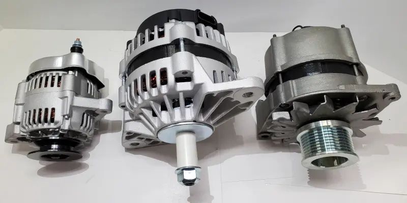 Close-up of a car alternator with silver housing and copper coils in the engine bay