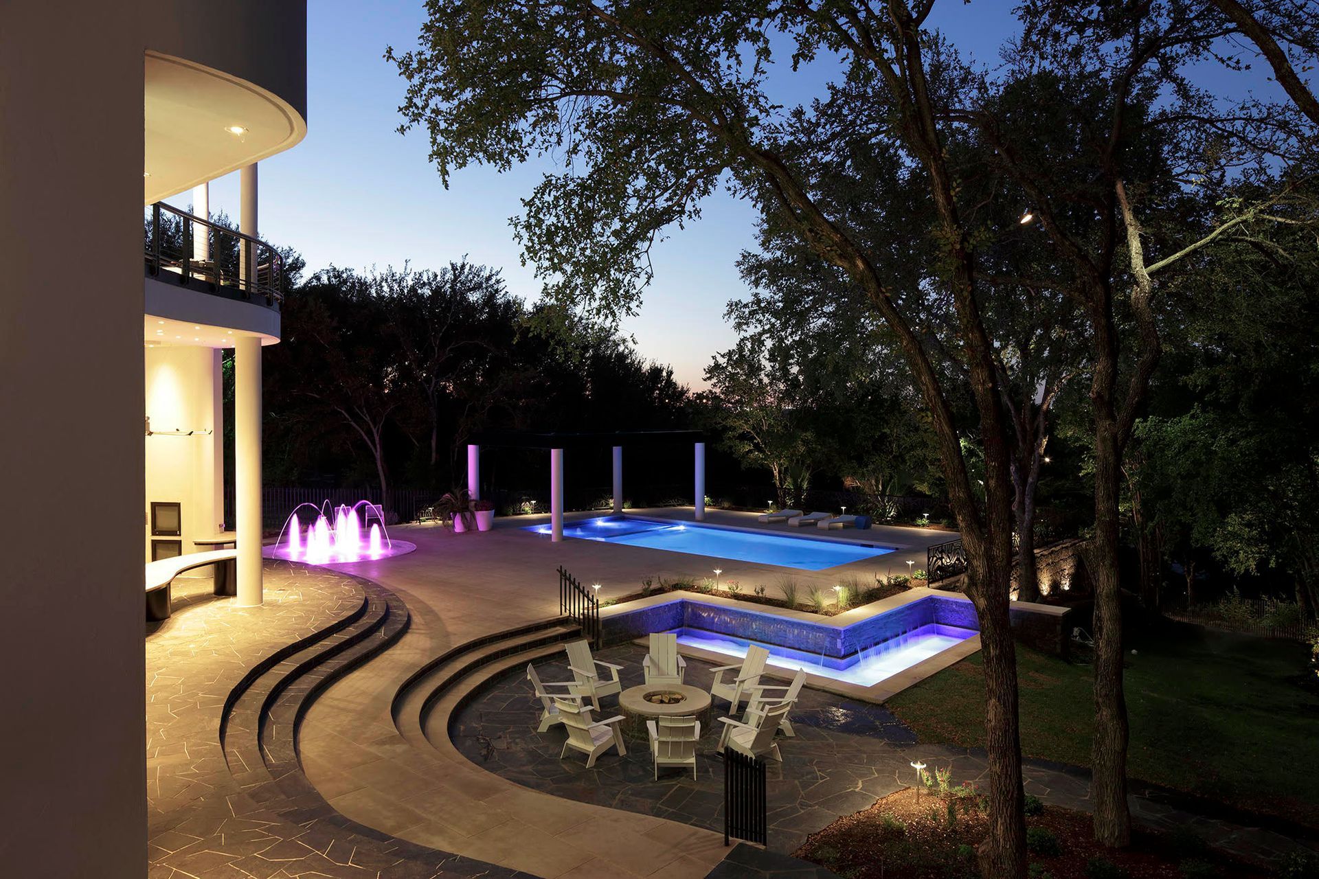 custom luxury pool and spa with outdoor seating area