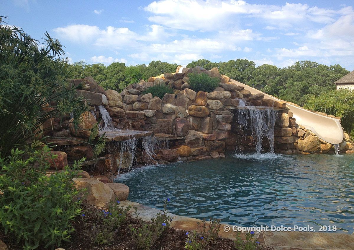 Luxury pool with rock waterfalls and slide in Dallas Fort Worth