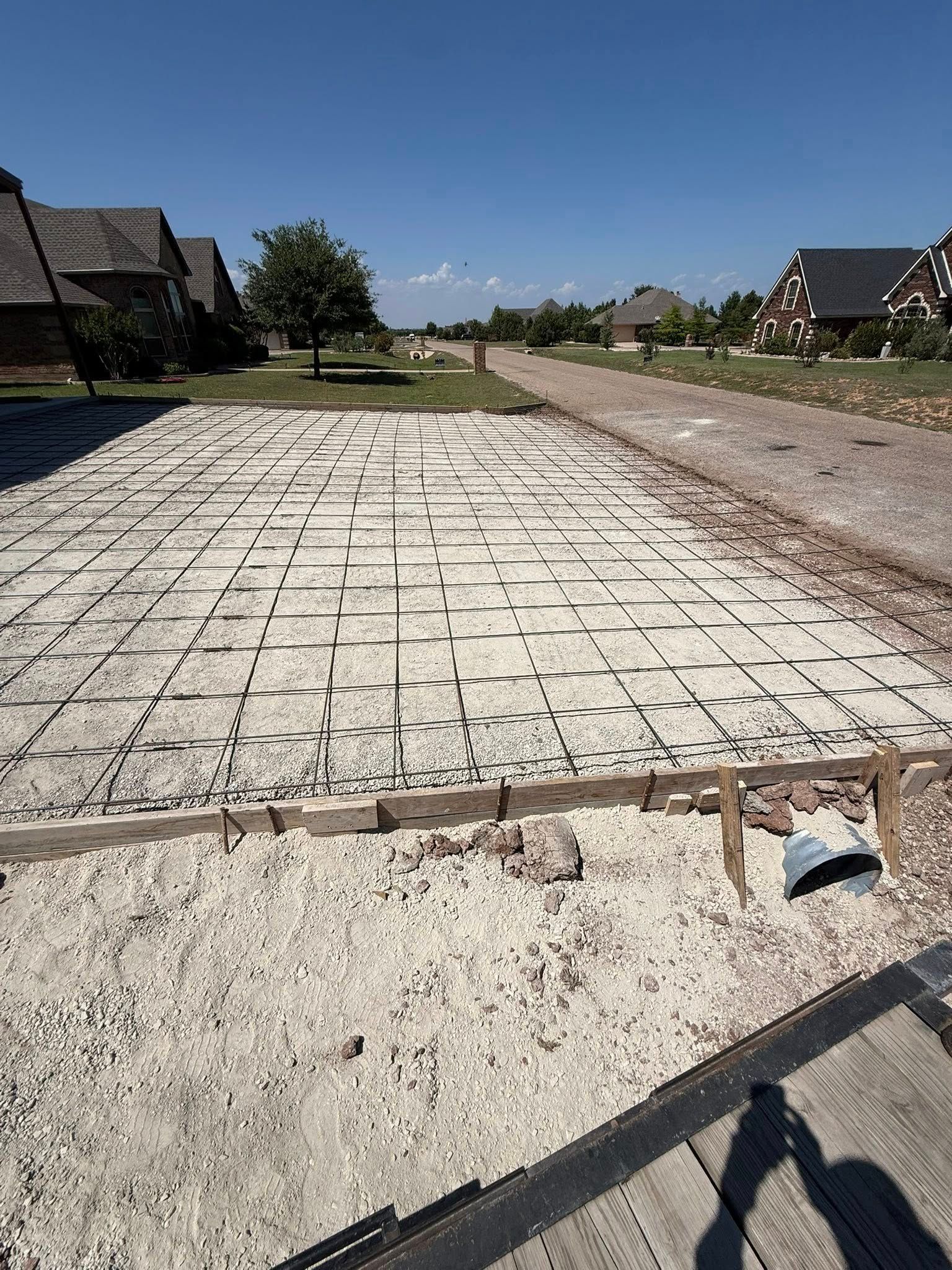 New cobblestone road under construction in a suburban neighborhood on a sunny day