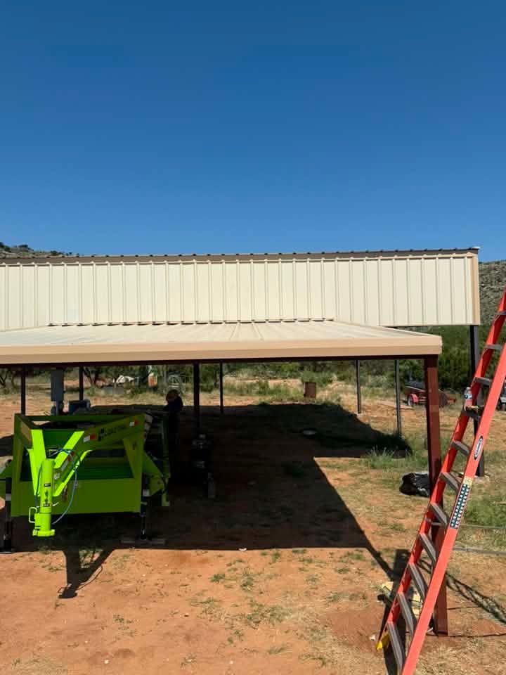 Rural metal shed raised on stilts, with a green machine underneath and a red ladder leaning on the right.