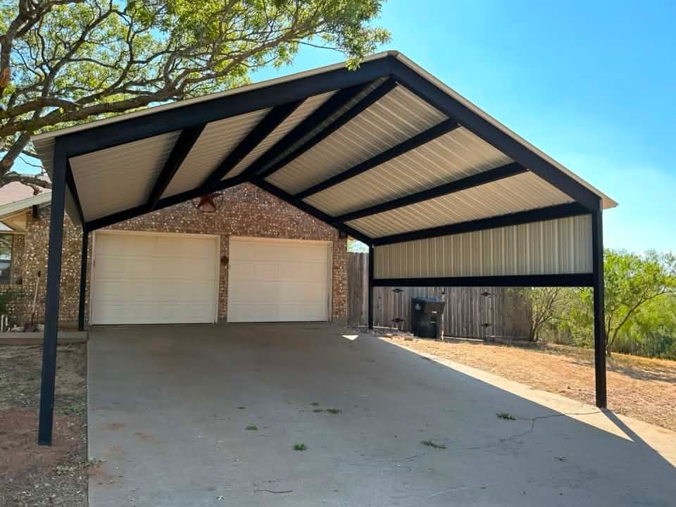 Covered driveway with a metal carport attached to a brick house and two garage doors