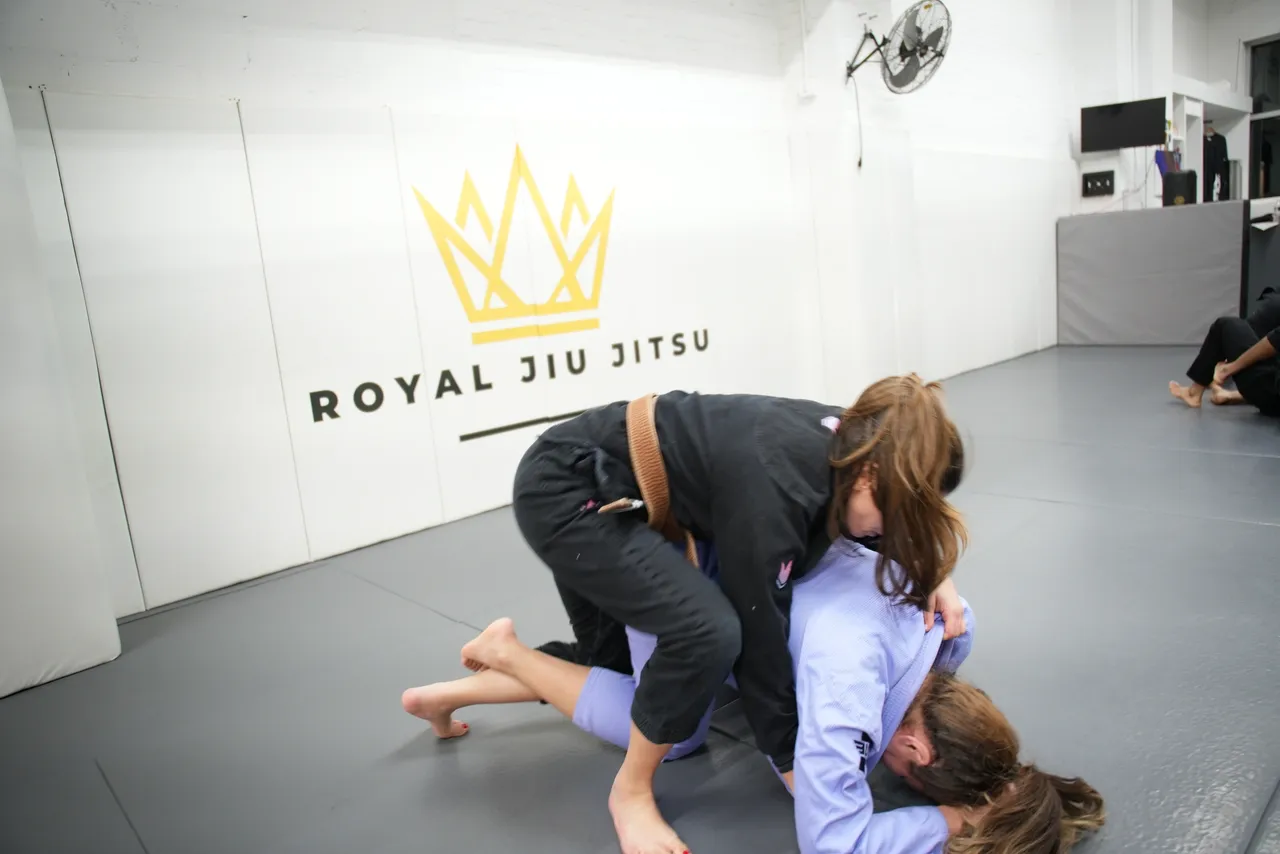 Adults training Brazilian Jiu Jitsu at Royal Jiu-Jitsu Queens in Queens, NY, building fitness.