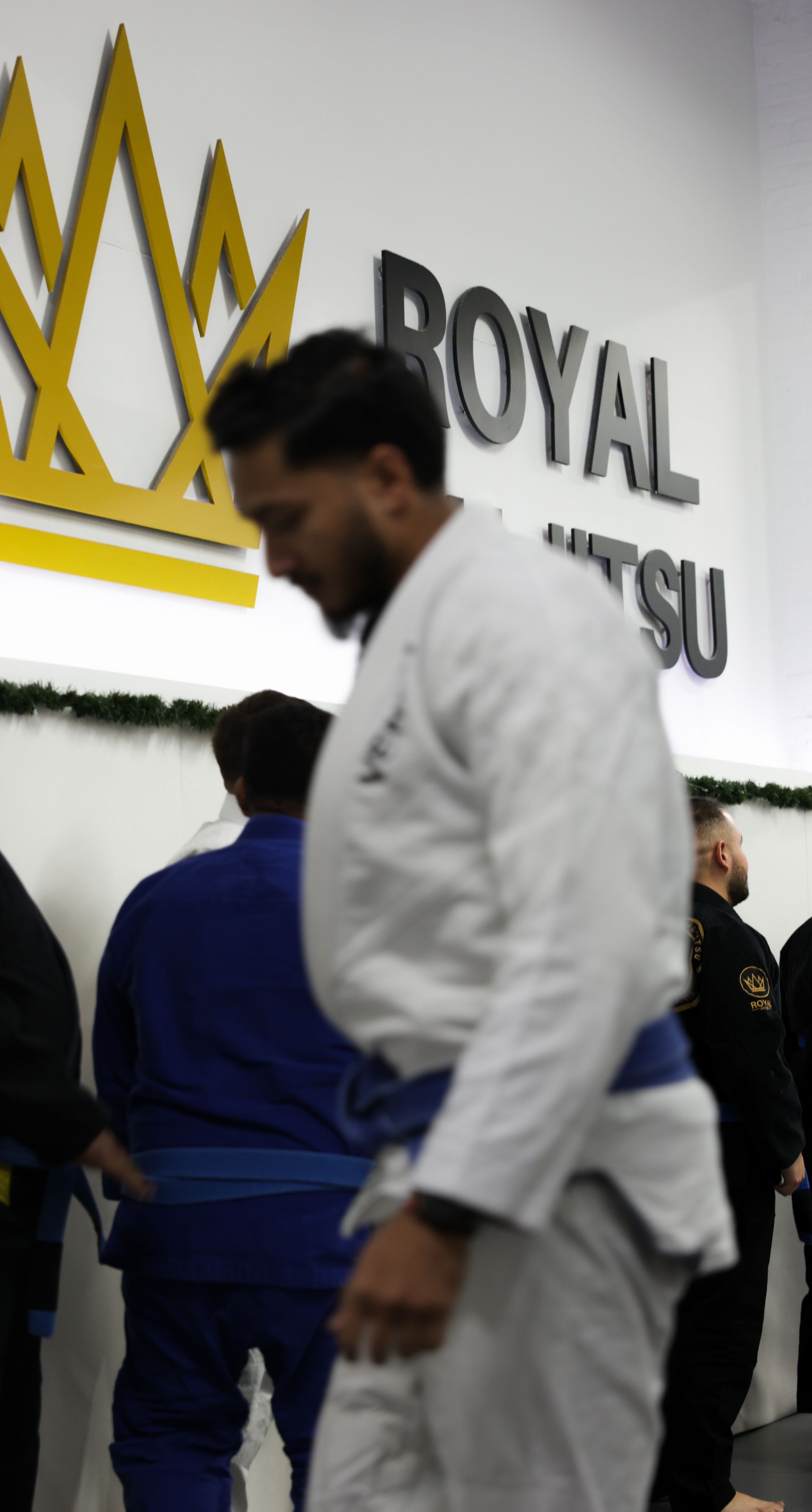 Adults drilling Brazilian Jiu-Jitsu at Royal Jiu-Jitsu Queens in Queens, NY, building fitness and calm control.