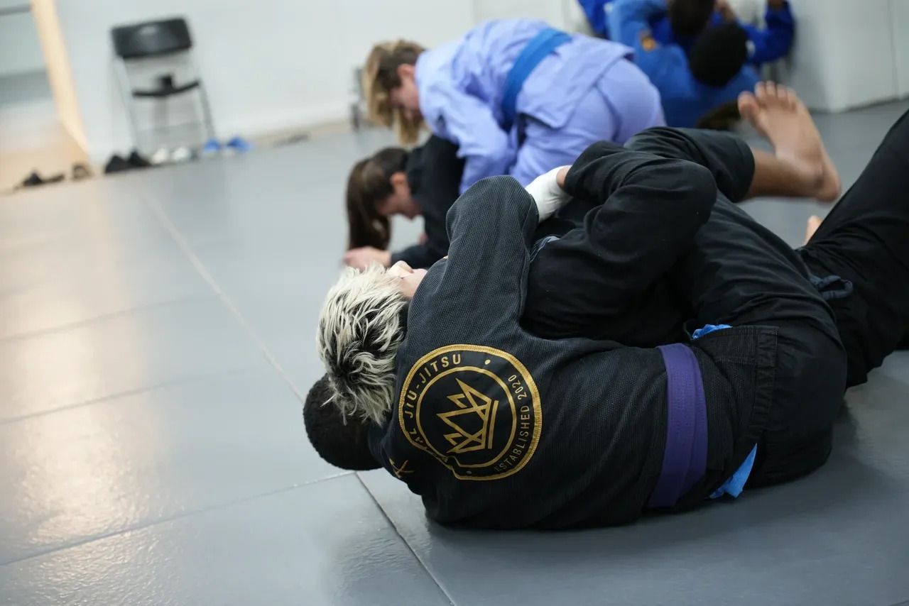 Adults training Brazilian Jiu-Jitsu at Royal Jiu-Jitsu Queens in Queens, NY, building fitness and re