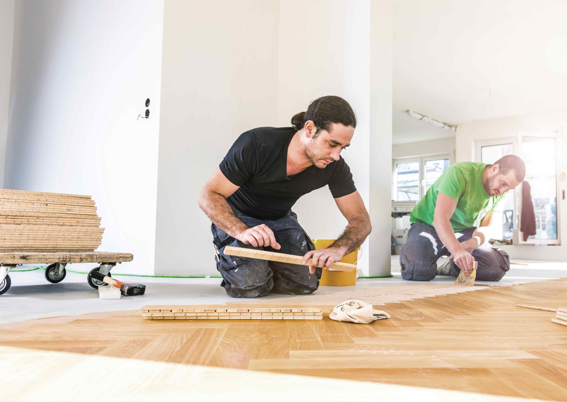 A person is using a machine to polish a wooden floor.