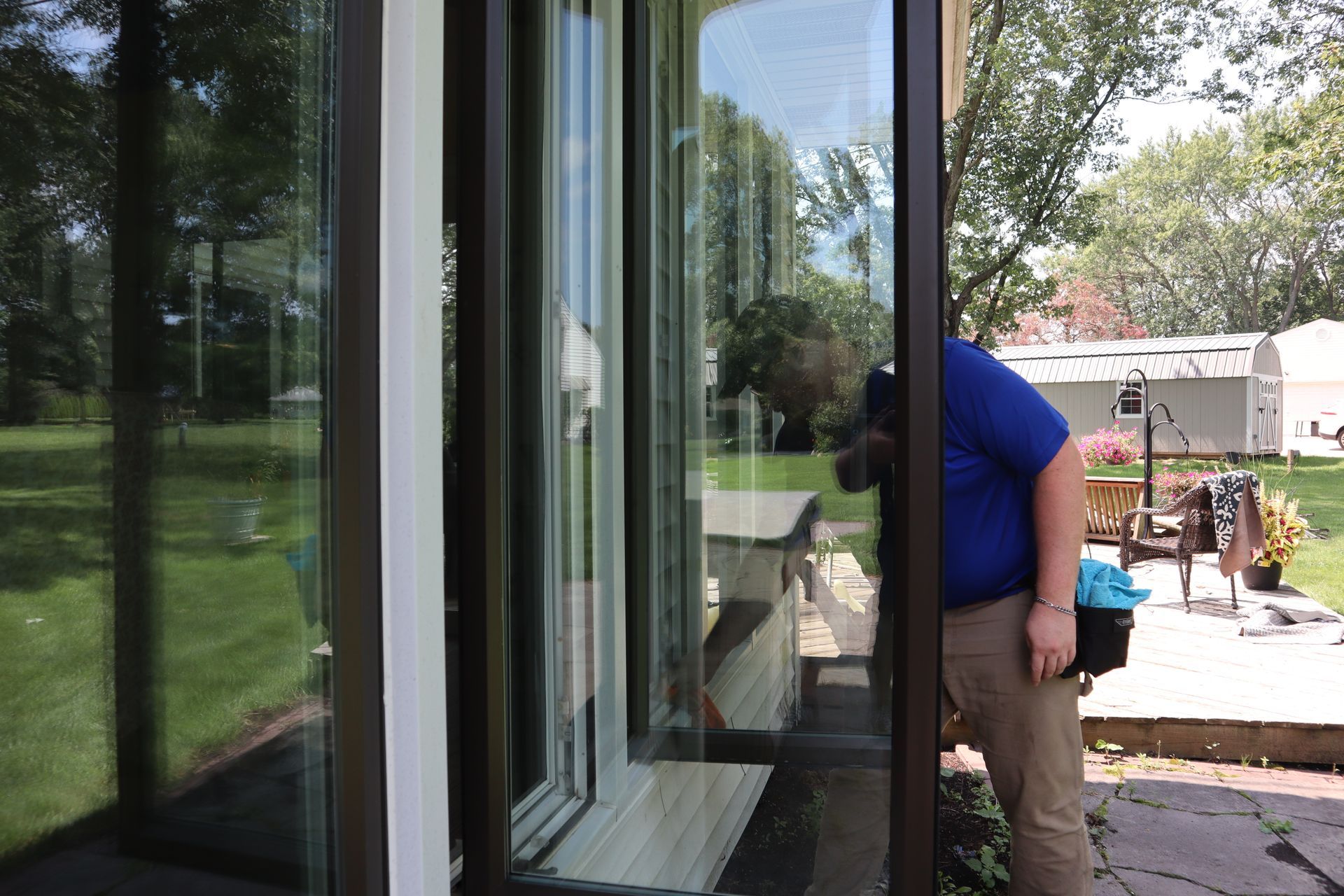 Clearsight Cleaning Services technician completing exterior glass door cleaning at a Tulsa commercial property