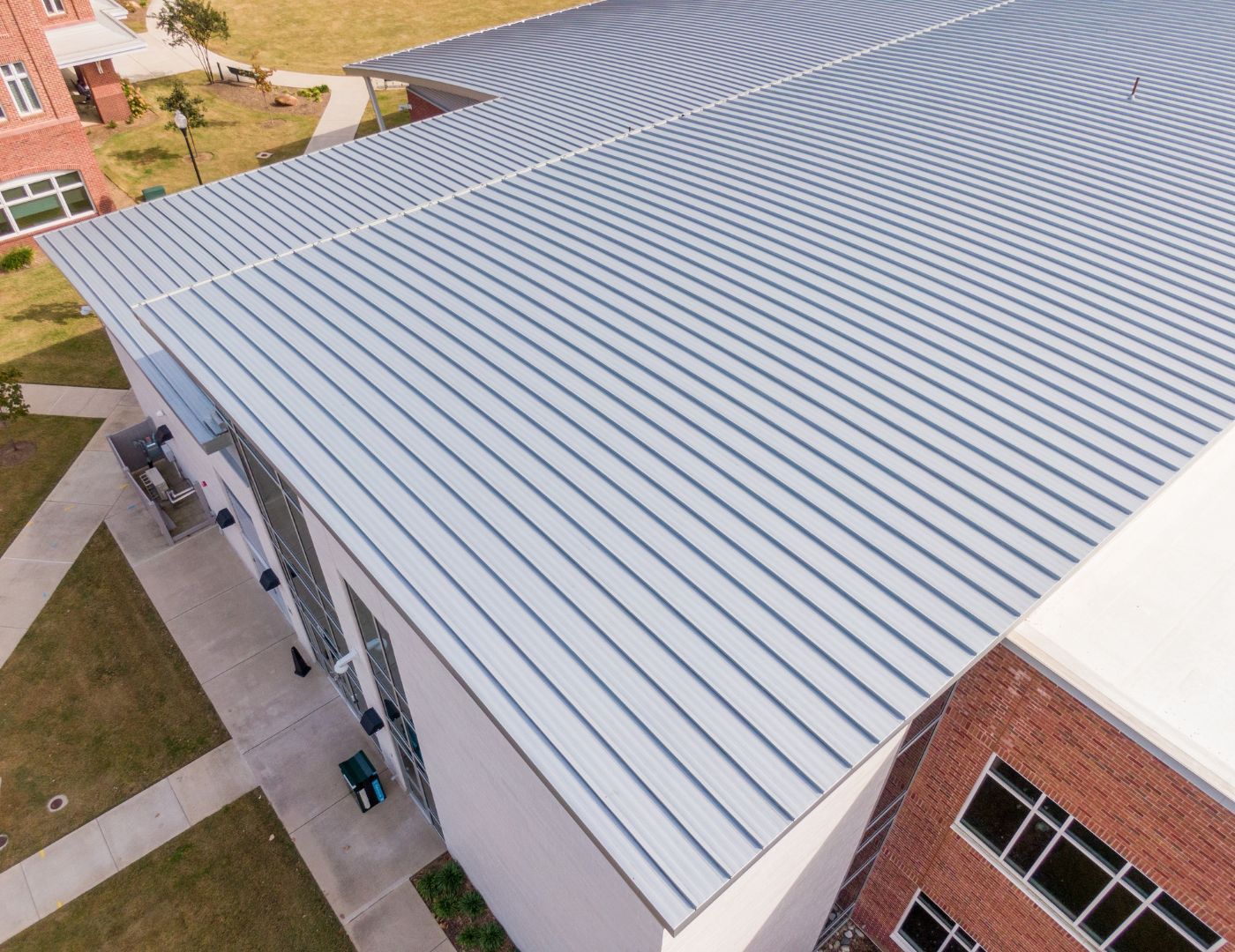 Commercial roofing technician evaluating a roof repair area