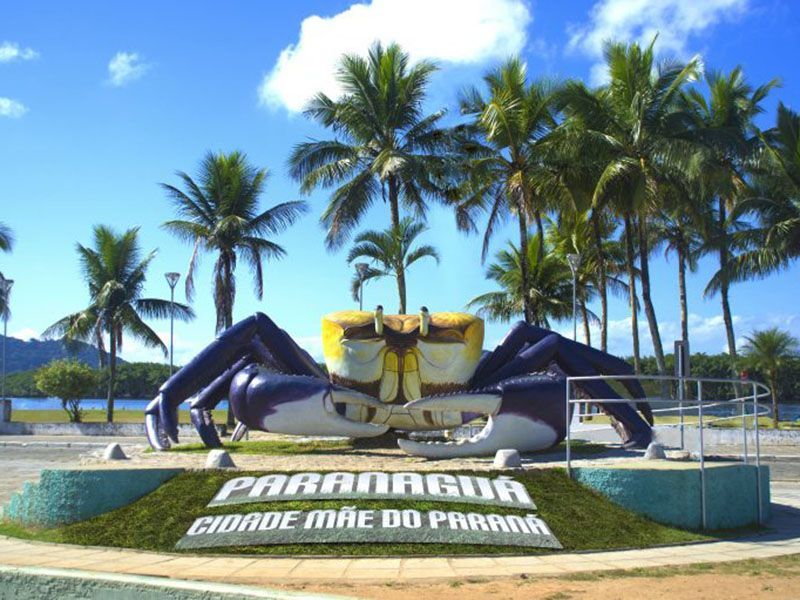 Large blue and yellow crab statue with the text 
