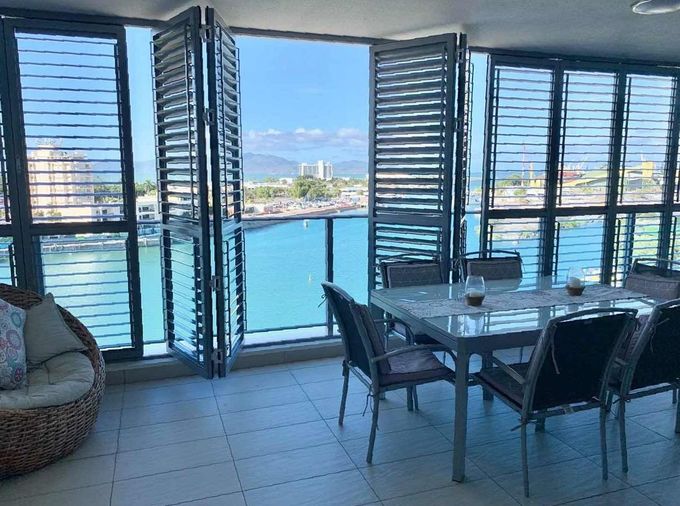 There is a Table and Chairs on the Patio With a View of the Backyard — Cover Me NQ in Currajong, QLD