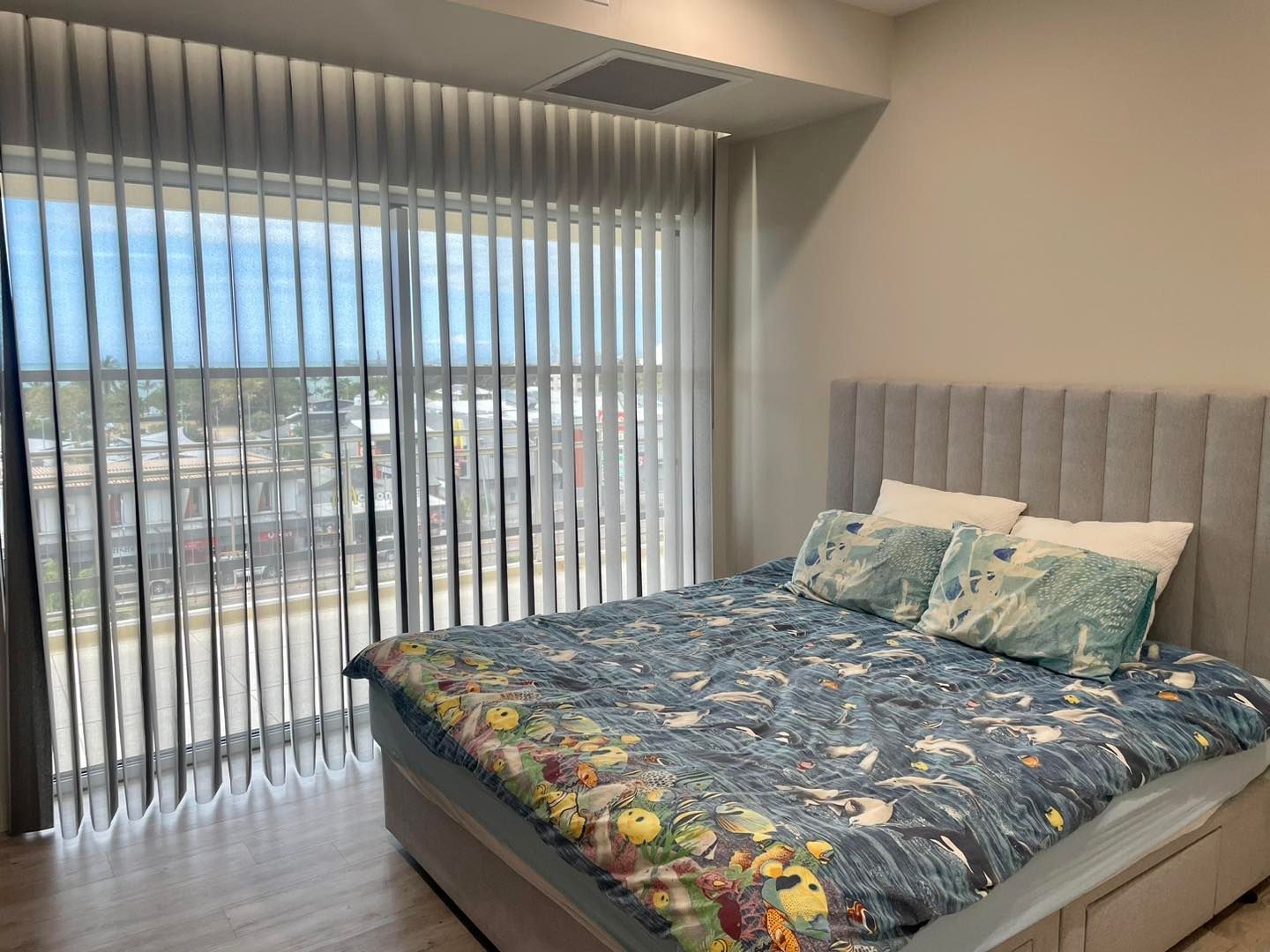 A Bedroom With a Large Bed and a Ceiling Fan — Cover Me NQ in Currajong, QLD