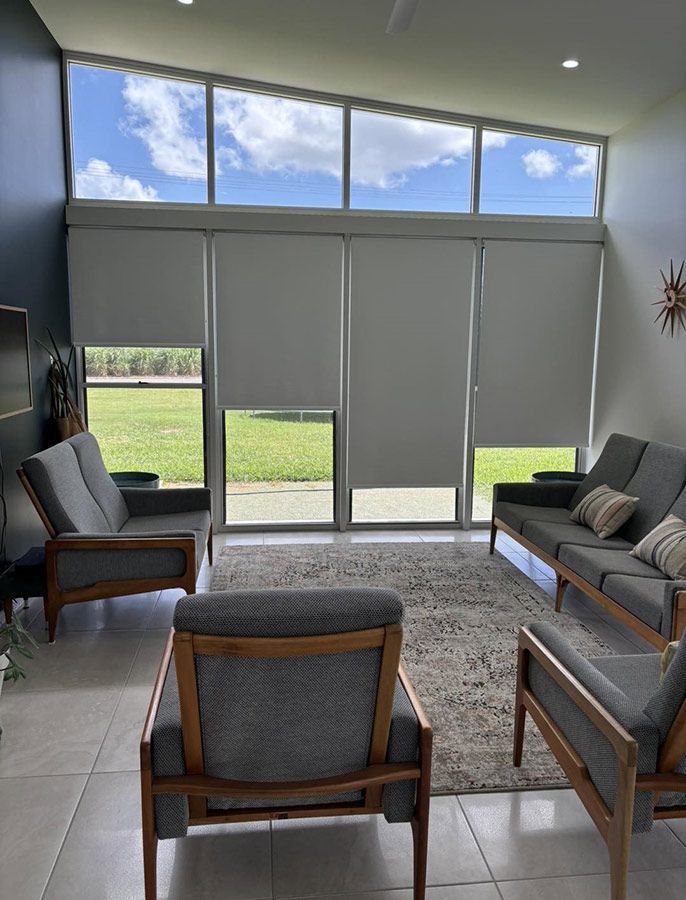 A Living Room With a Couch and Chairs and a Large Window — Cover Me NQ in Currajong, QLD