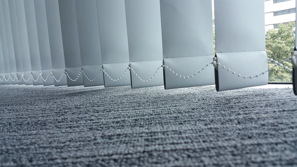 A Row of Vertical Blinds on a Carpeted Floor in an Office — Cover Me NQ in Currajong, QLD