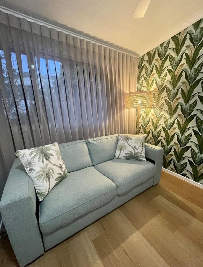 A Living Room With a Couch and a Lamp — Cover Me NQ in Currajong, QLD