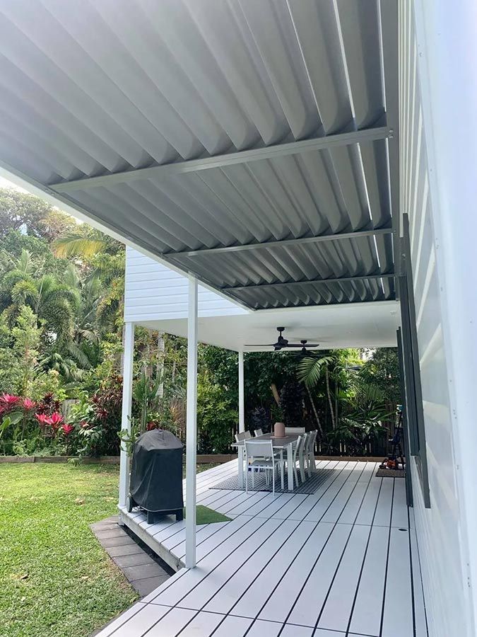 A White Deck With a Dining Table and Chairs Under a Canopy — Cover Me NQ in Currajong, QLD