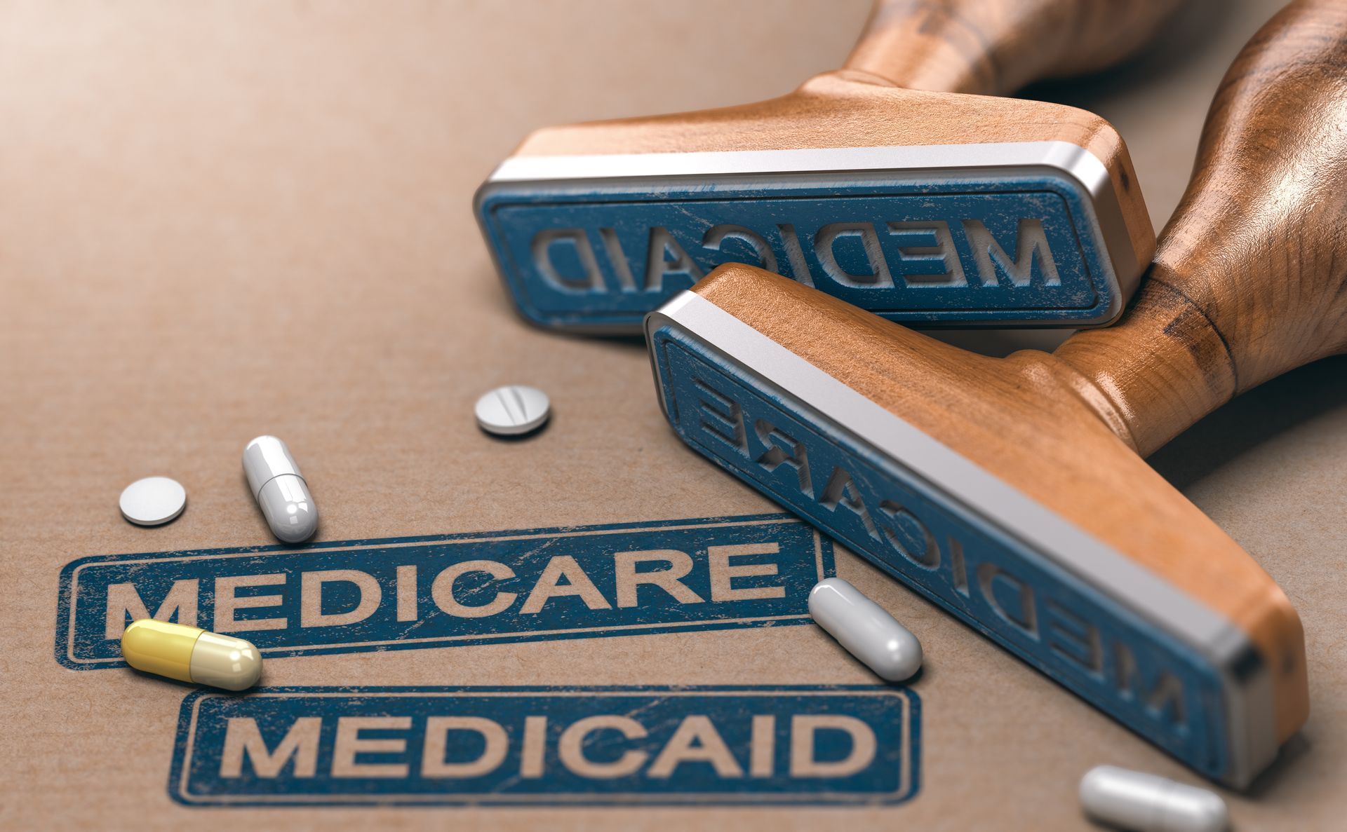 Medicare and Medicaid stamps with loose pills on a wooden surface