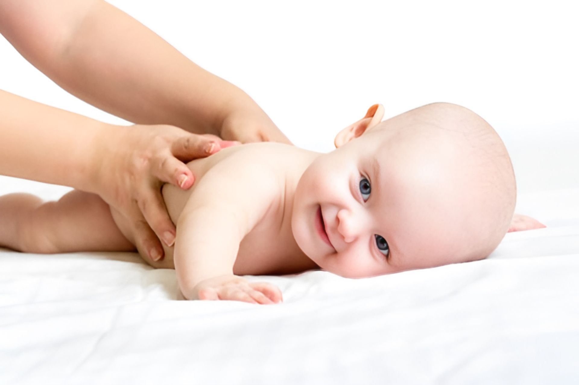 A Woman is Giving a Baby a Massage — Newcastle Paediatric Occupational Therapy In Floraville, NSW