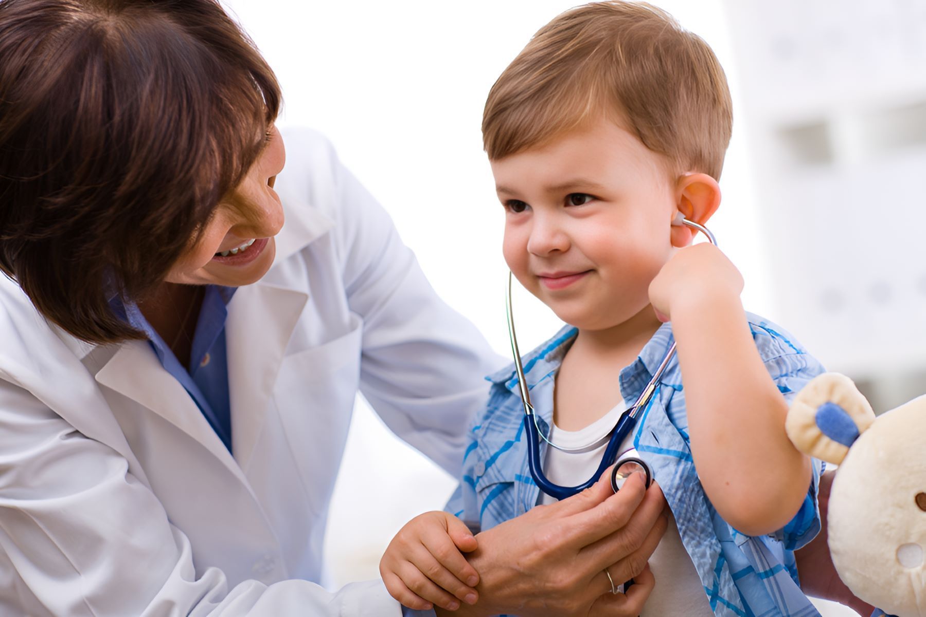 A Doctor is Examining a Young Boy With a Stethoscope — Newcastle Paediatric Occupational Therapy In Floraville, NSW
