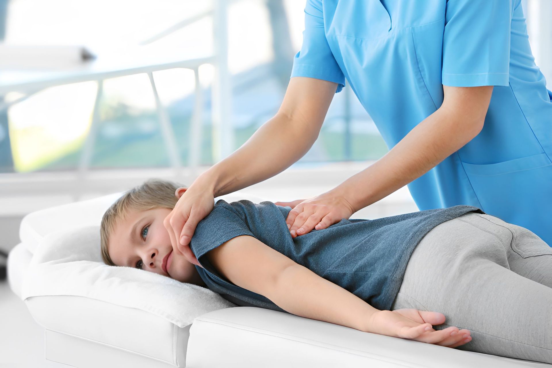 A Young Boy is Laying on a Bed Getting a Massage — Newcastle Paediatric Occupational Therapy in Hunter Region, NSW