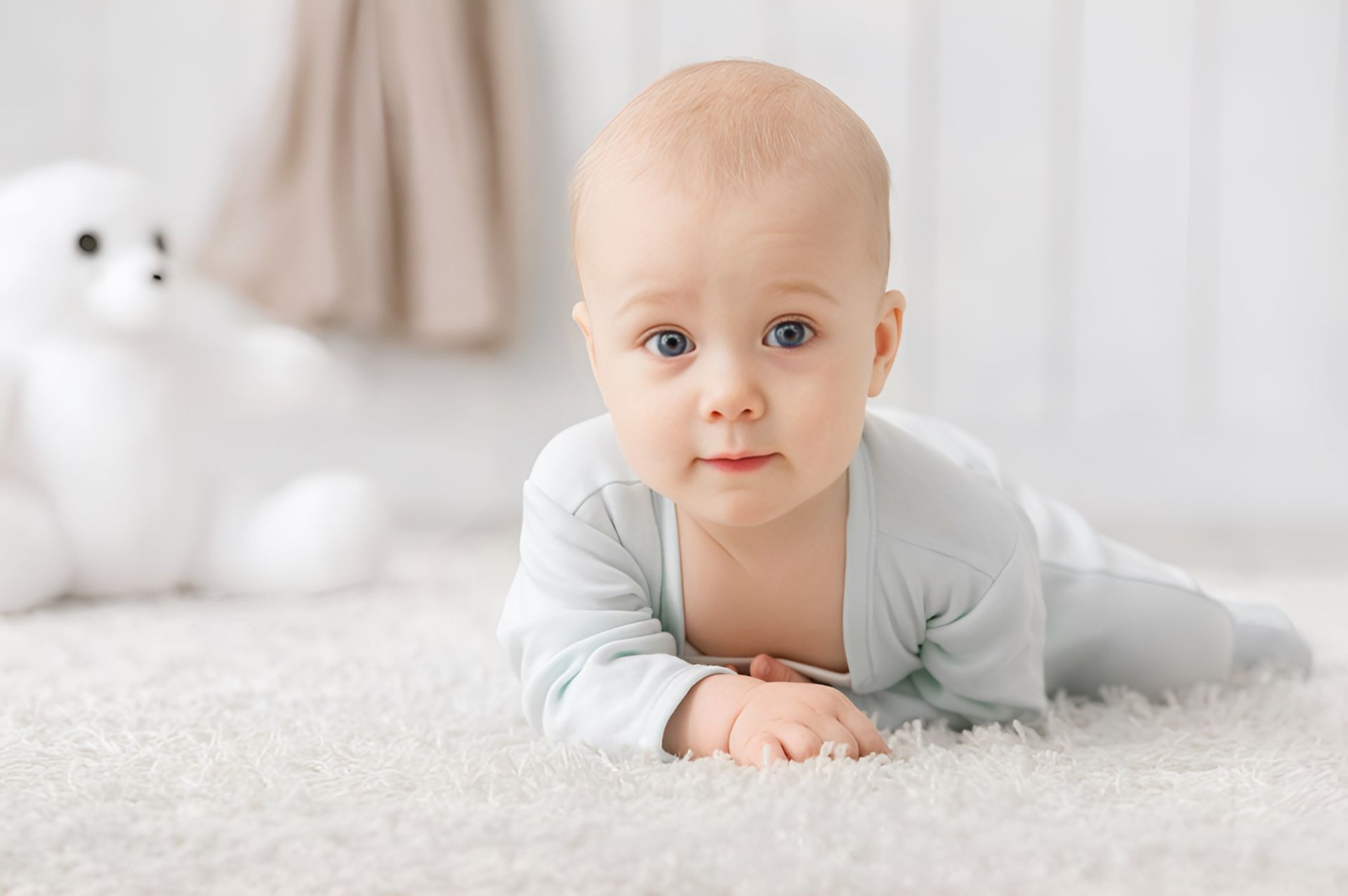 A Baby is Crawling on Its Stomach on a White Carpet — Newcastle Paediatric Occupational Therapy in Floraville, NSW