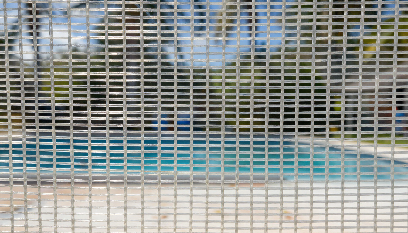Close-up of fiberglass pool cage screen mesh in Florida sunlight