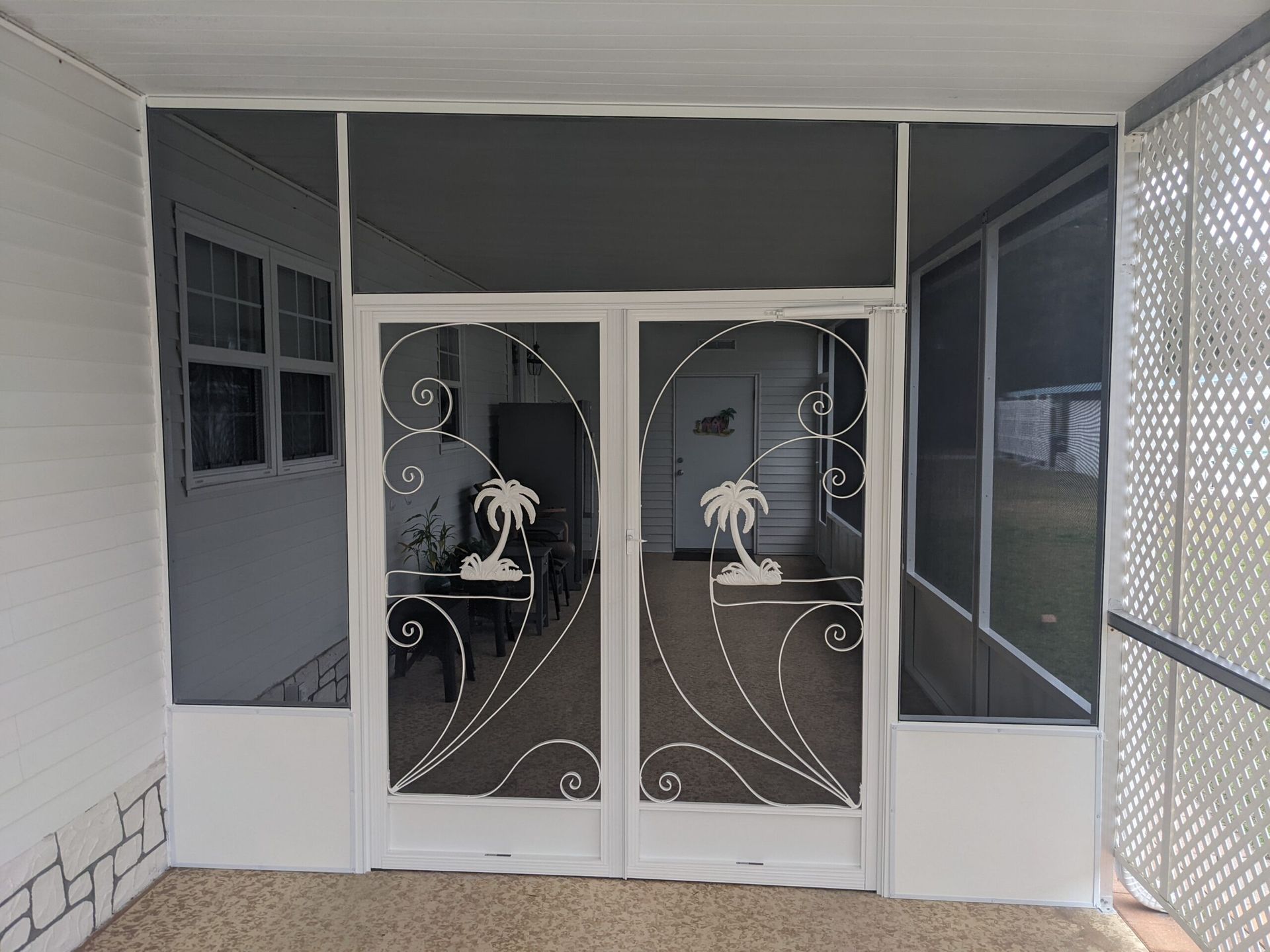 White double front doors with decorative glass panels and gray side panels under a covered porch