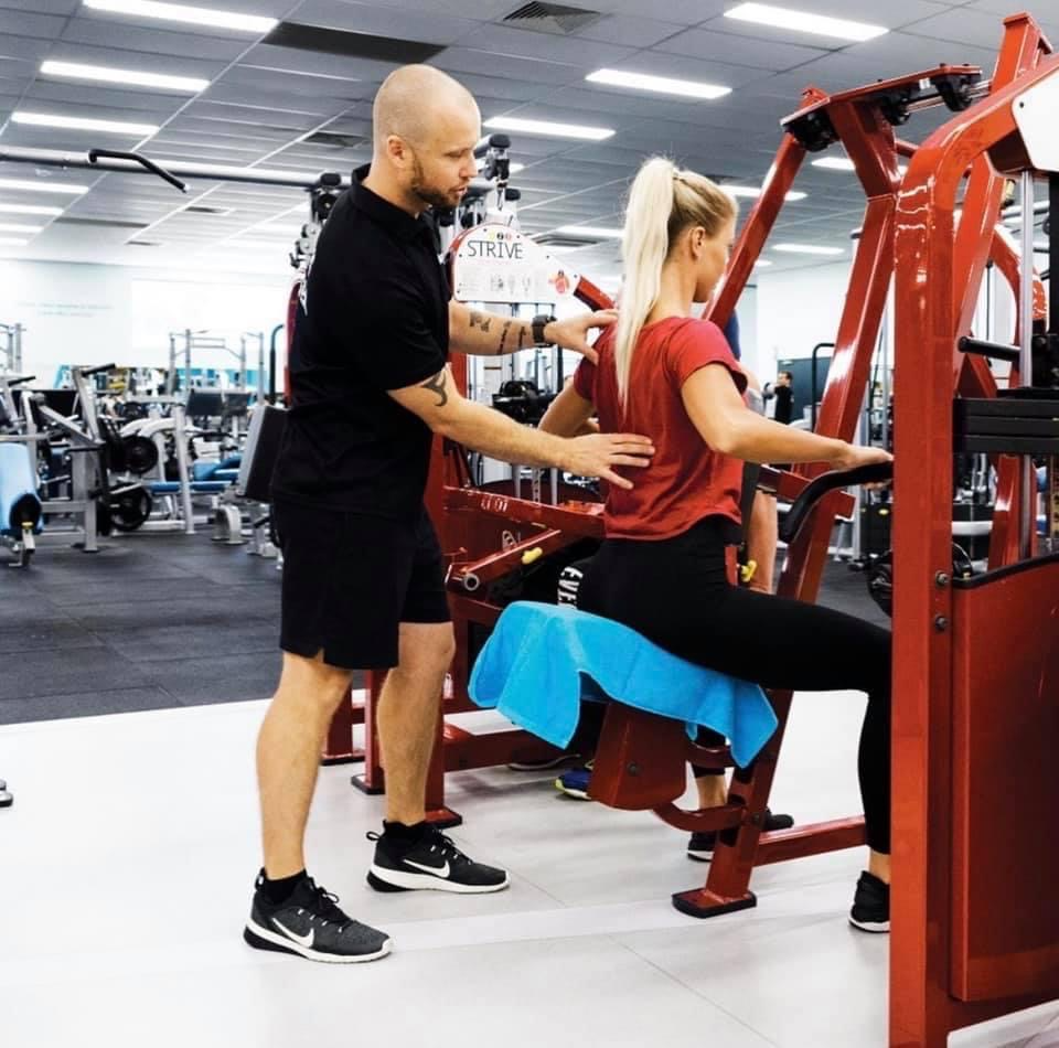 Bronx Training personal trainers helping client with technique in the Gym