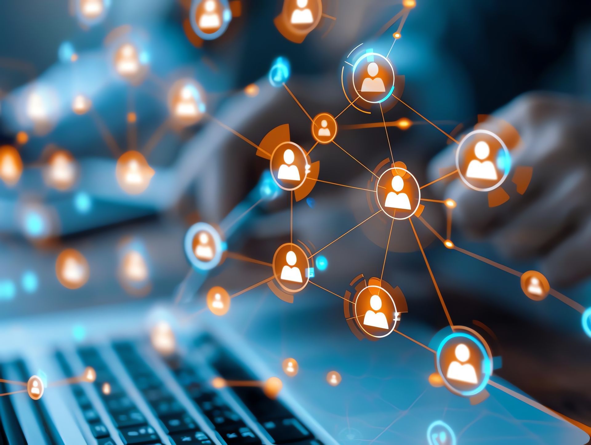 Hands using a laptop with a digital overlay of glowing, interconnected network nodes and human-shaped icons.