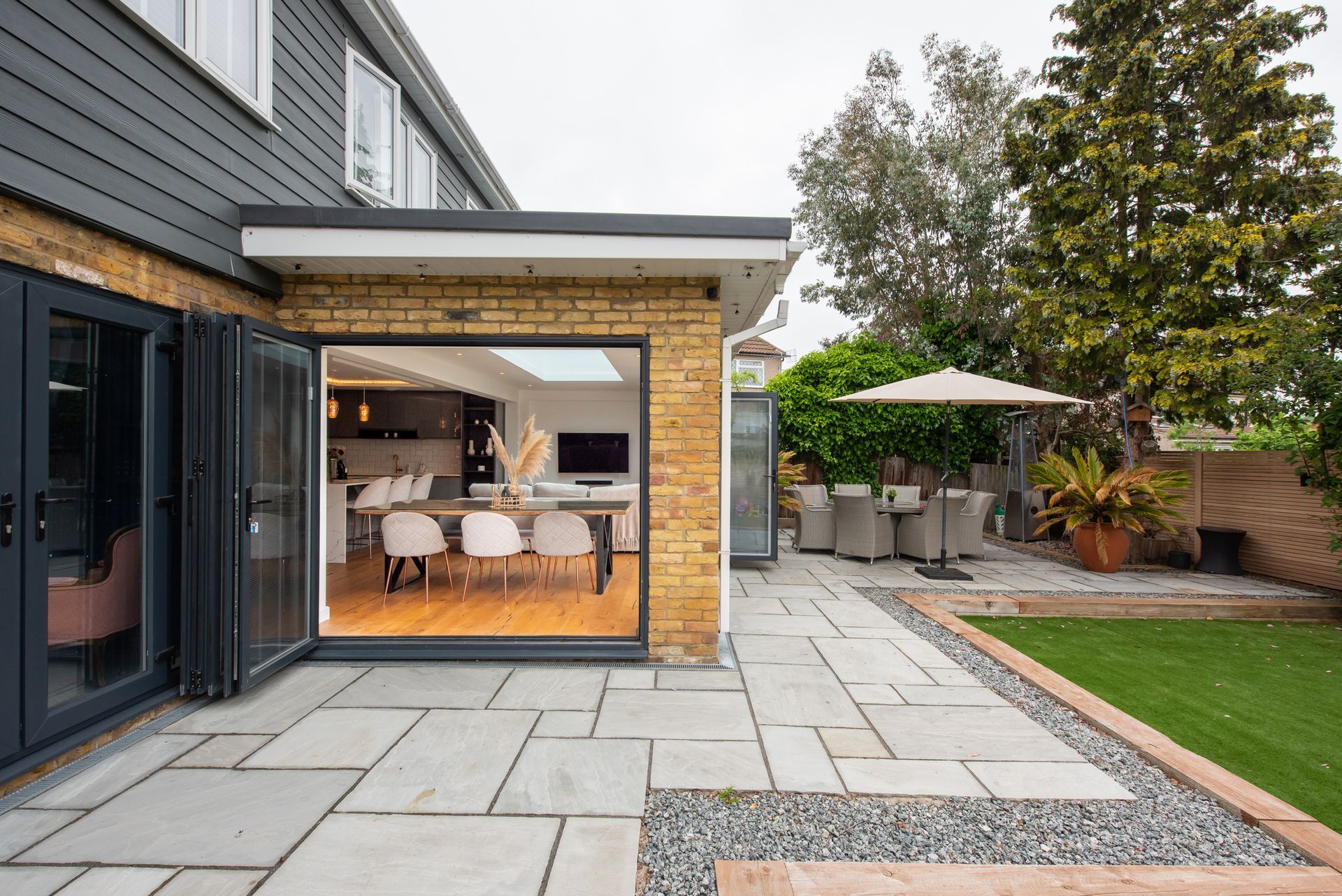 A house with a patio and a table and chairs in the backyard | Louisville, KY | S & S Concrete Inc.