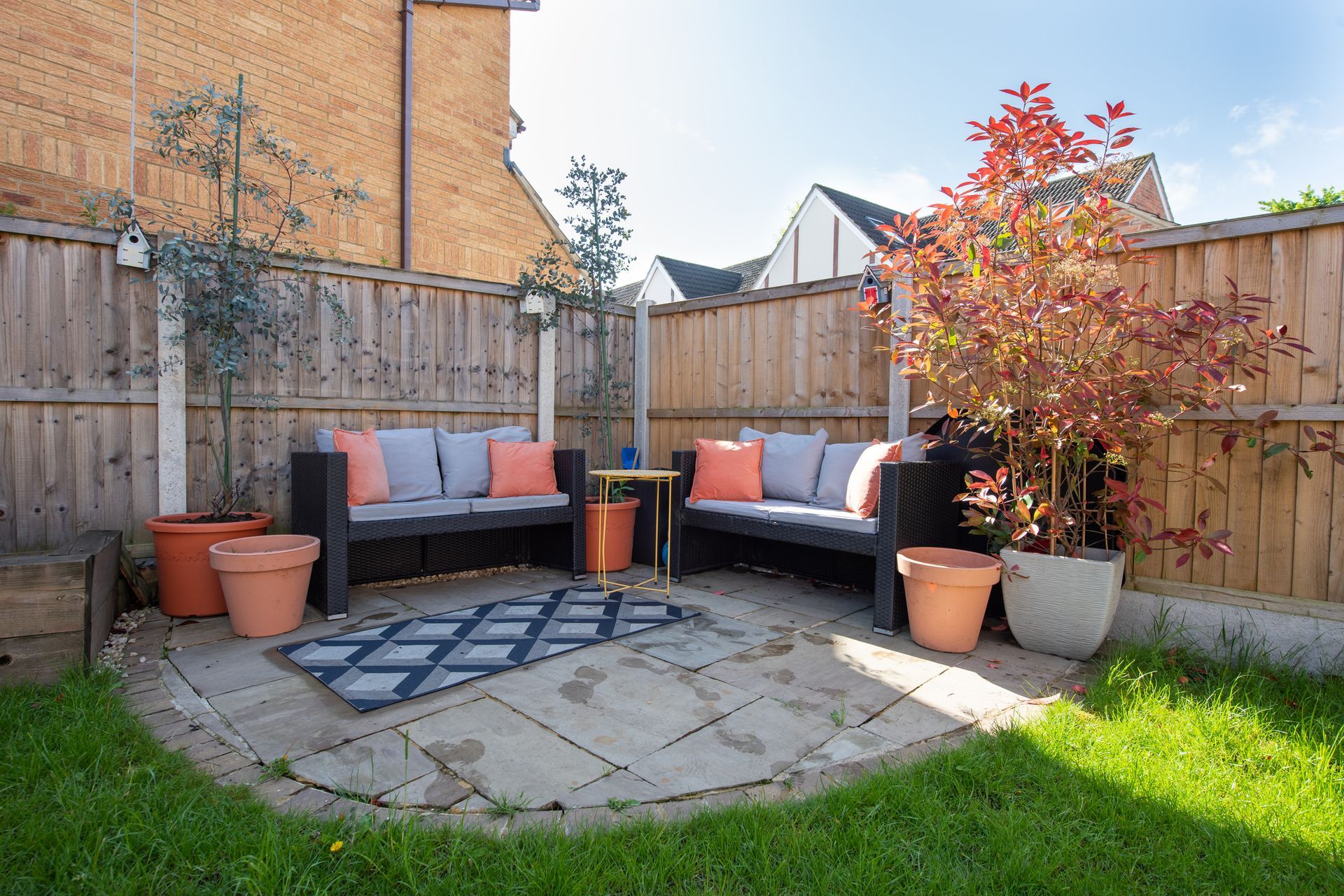 There is a patio with a couch and a table in the backyard | Louisville, KY | S & S Concrete Inc.