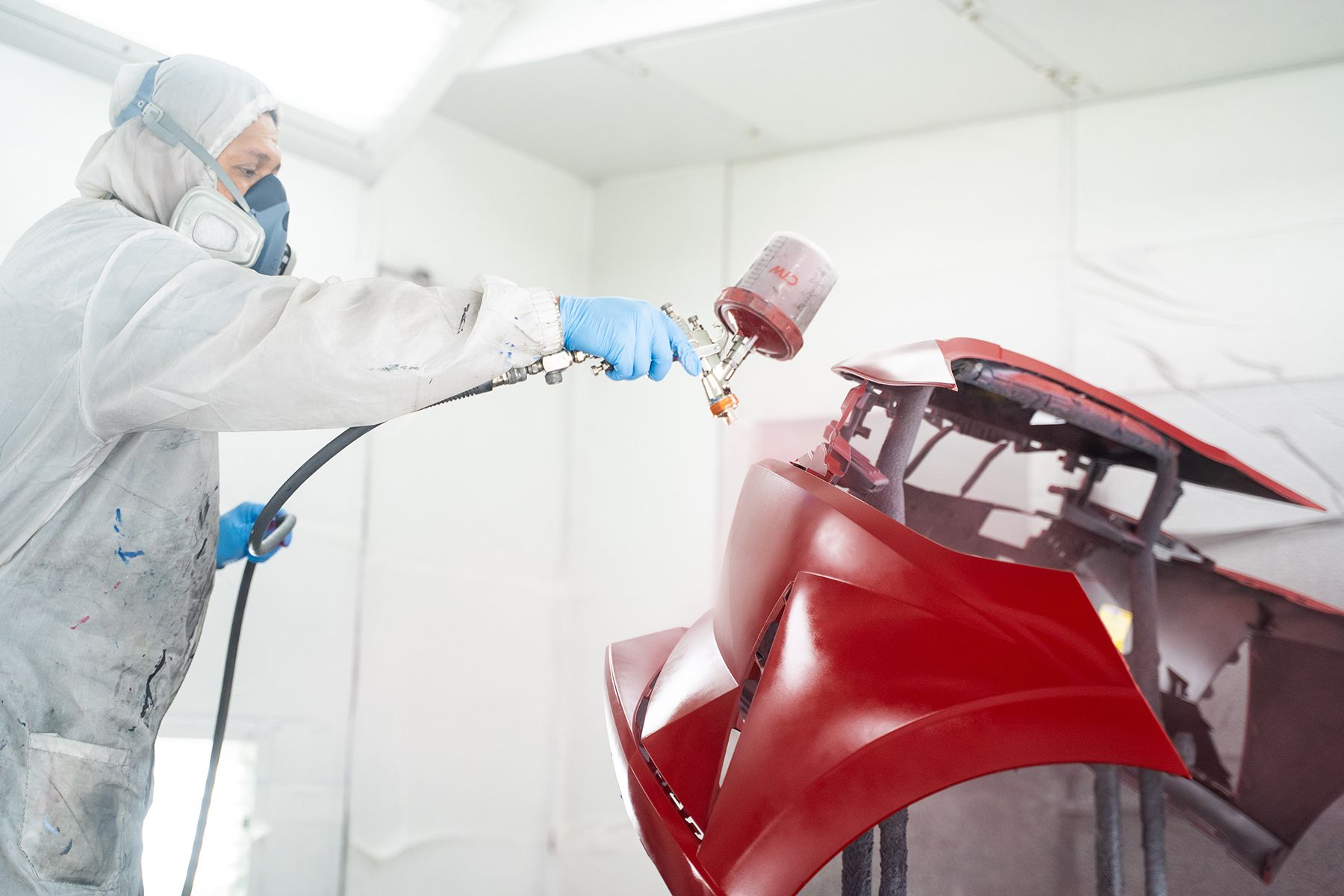 Coating red paint on front of car in Fishkill, NY | Jimmy's Auto Outlet