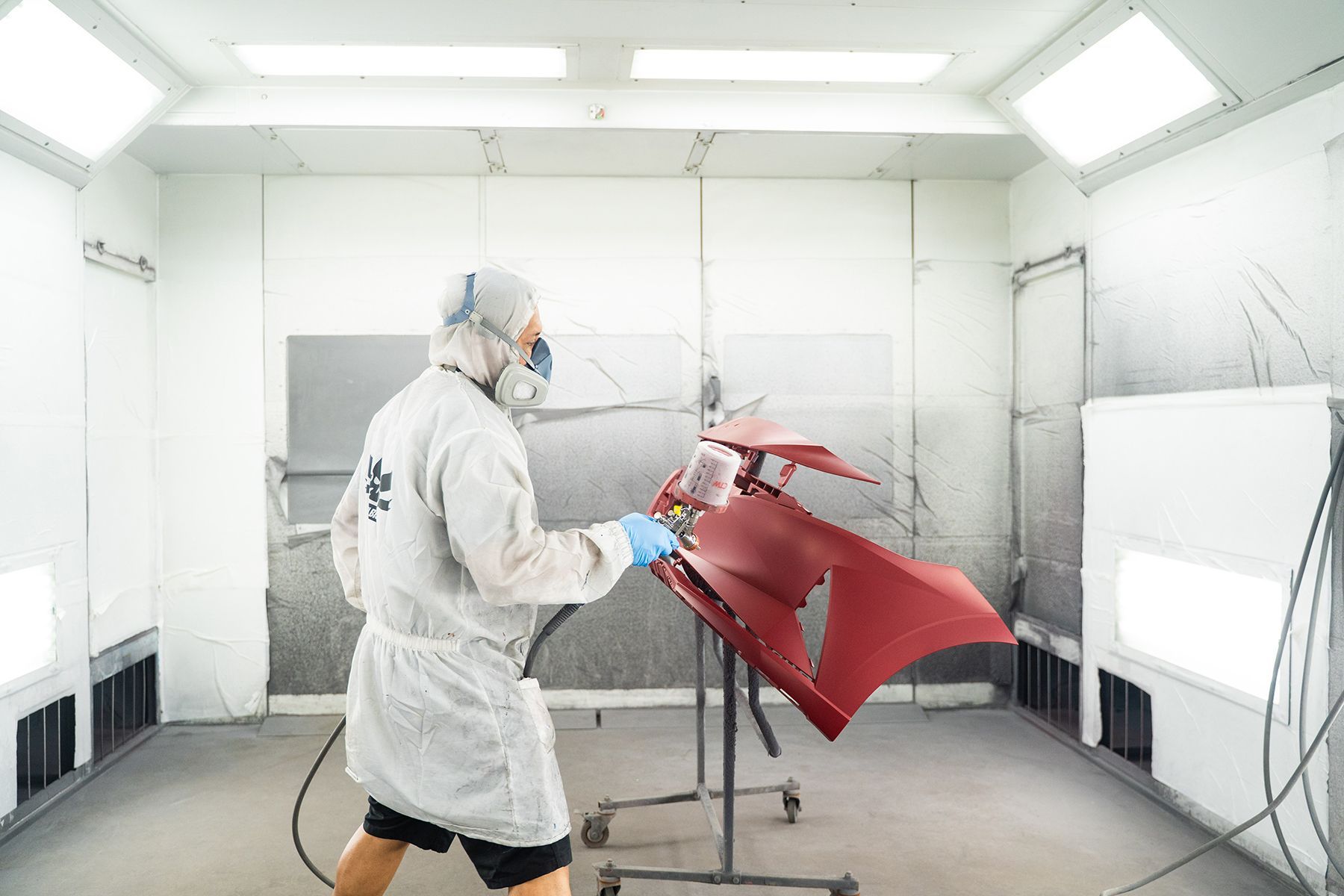 Coating red paint on front of car in Fishkill, NY | Jimmy's Auto Outlet