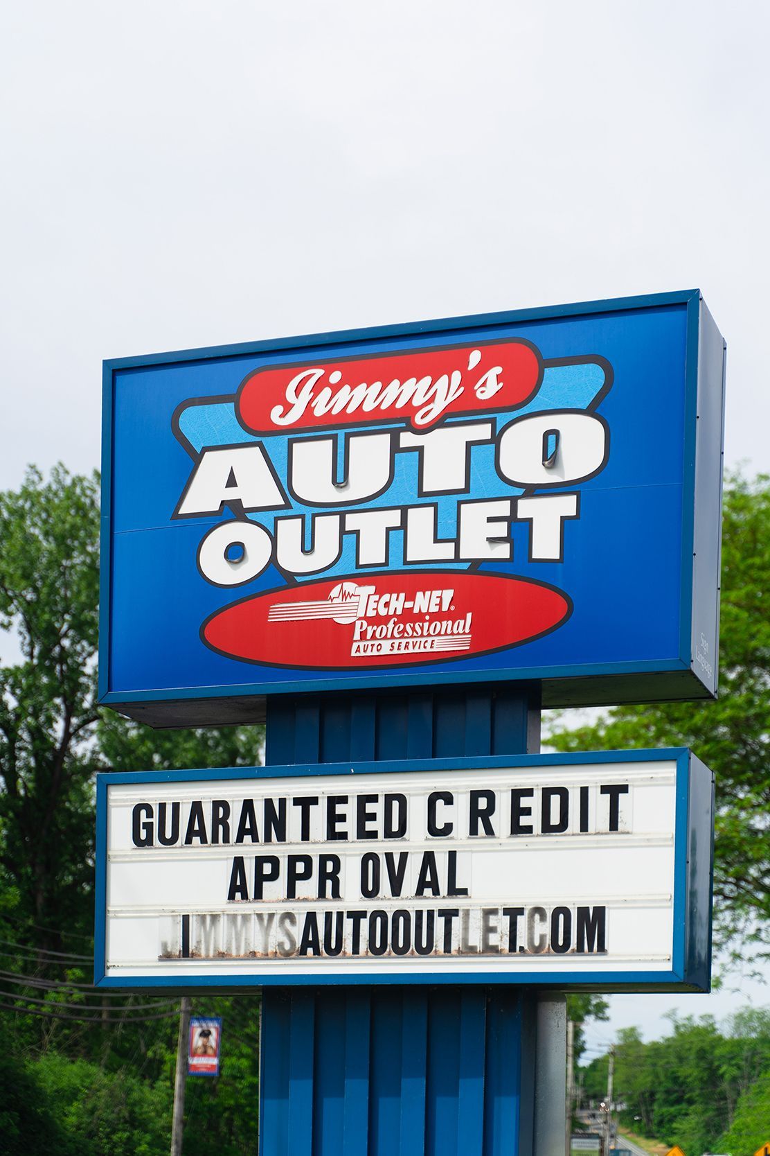 Logo on our shop sign outside in Fishkill, NY | Jimmy's Auto Outlet