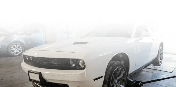 White Mustang Parked Inside Garage for Used Car Sales | Jimmy's Auto Outlet
