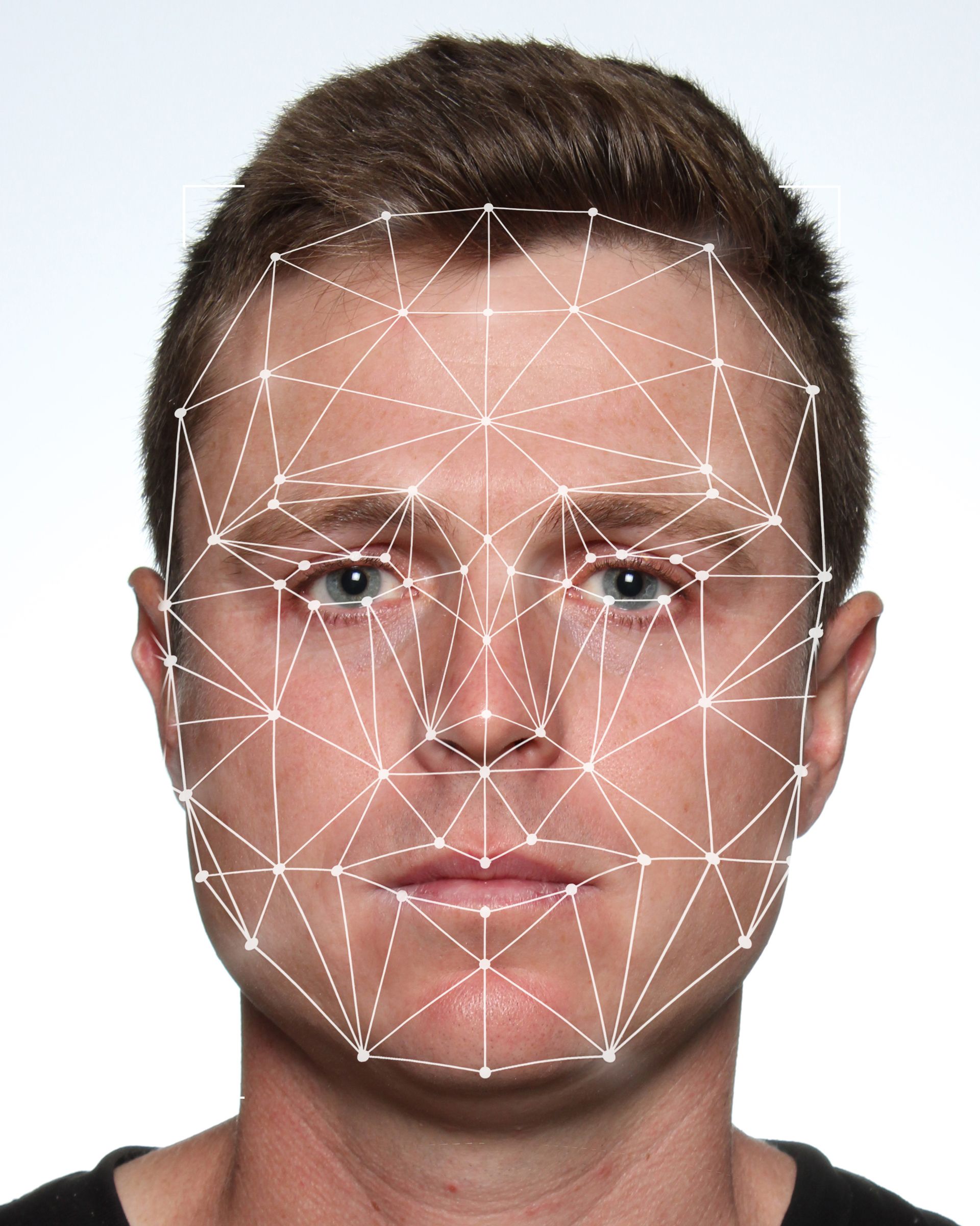 A man's face with a white grid overlaid, likely for facial recognition analysis — Dale Wright Portrait Maker in Shepparton, VIC
