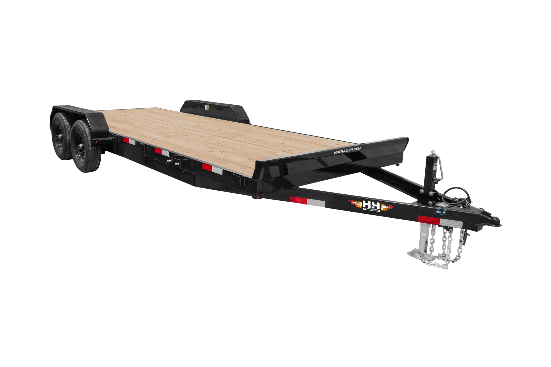 Black and tan flatbed trailer; wooden deck; two axles; hitch with safety chains; white background.