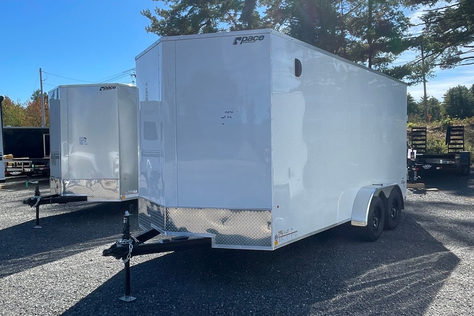 White enclosed cargo trailer on a sunny day.