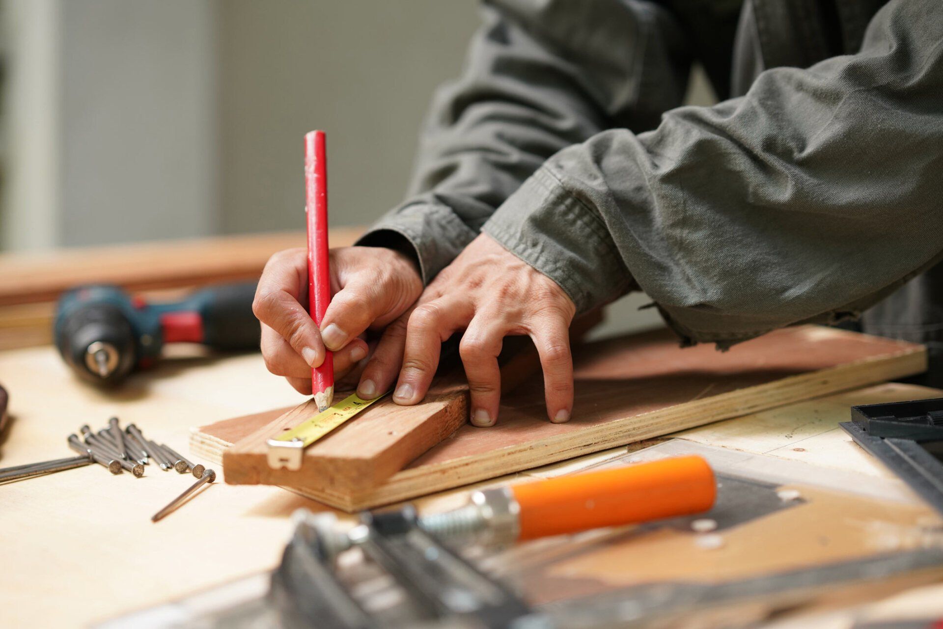Carpenter Using Tape Measure — New Castle, DE — Pedrozas Painting LLC