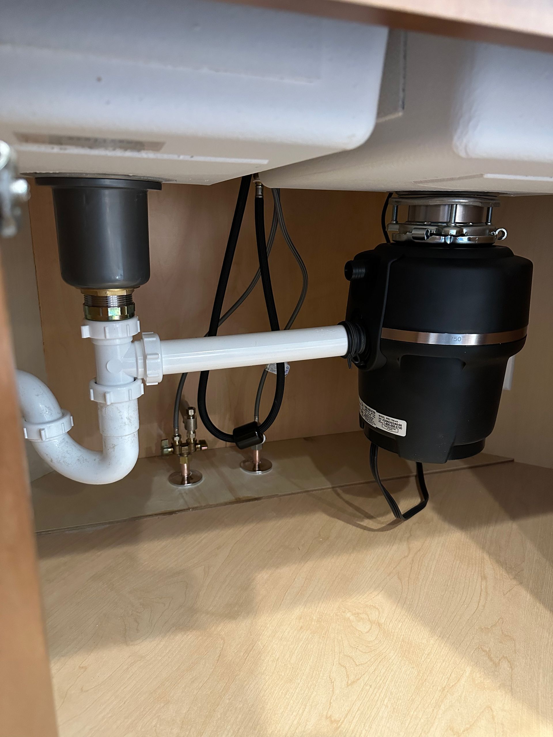 Person using garbage disposal with food in the sink.