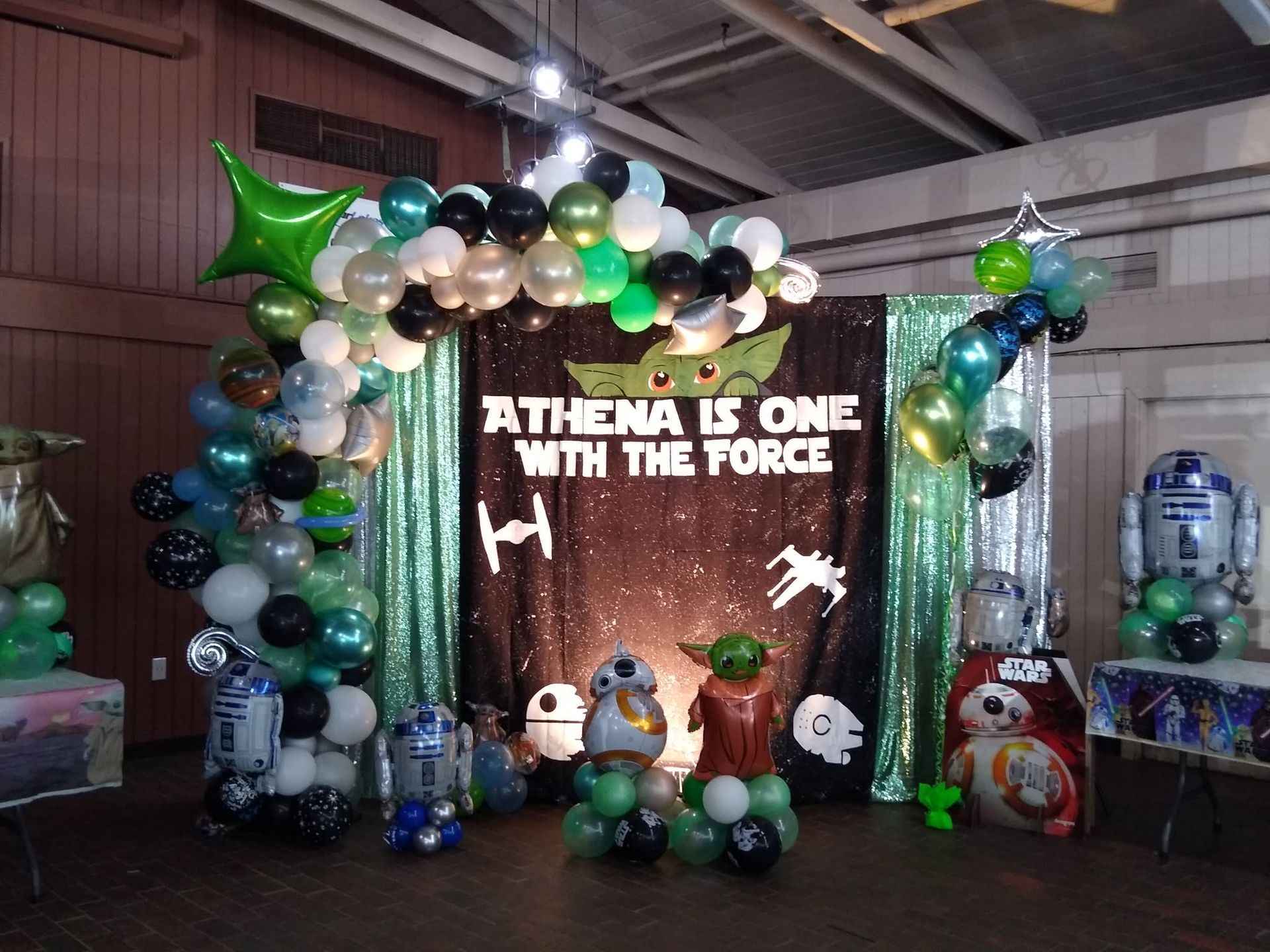 Star Wars-themed balloon display with “ATHENA IS ONE WITH THE FORCE” sign and character cutouts