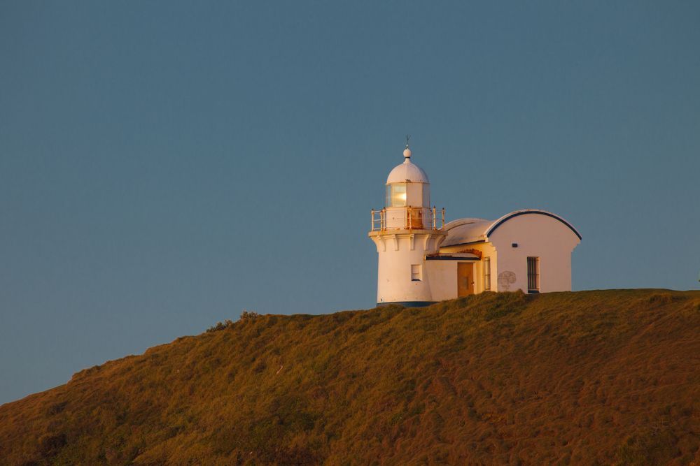 White Lighthouse on a Grassy Hill — Dave's Drive U Anywhere 24/7 Mini Van Hire In Albion Park, NSW