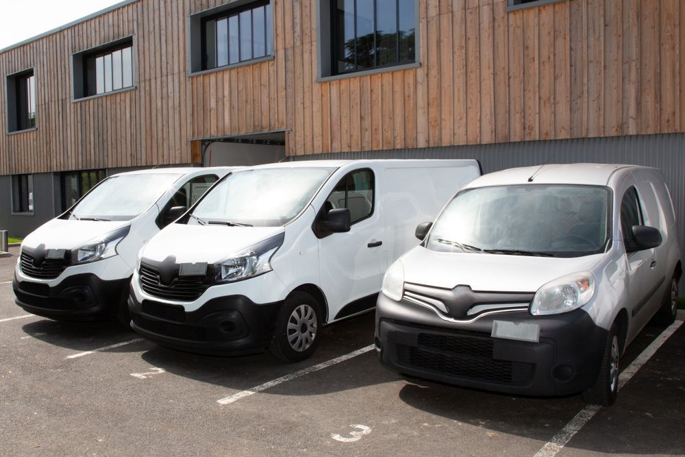 Three White Vans Parked — Dave's Drive U Anywhere 24/7 Mini Van Hire In Bulli, NSW