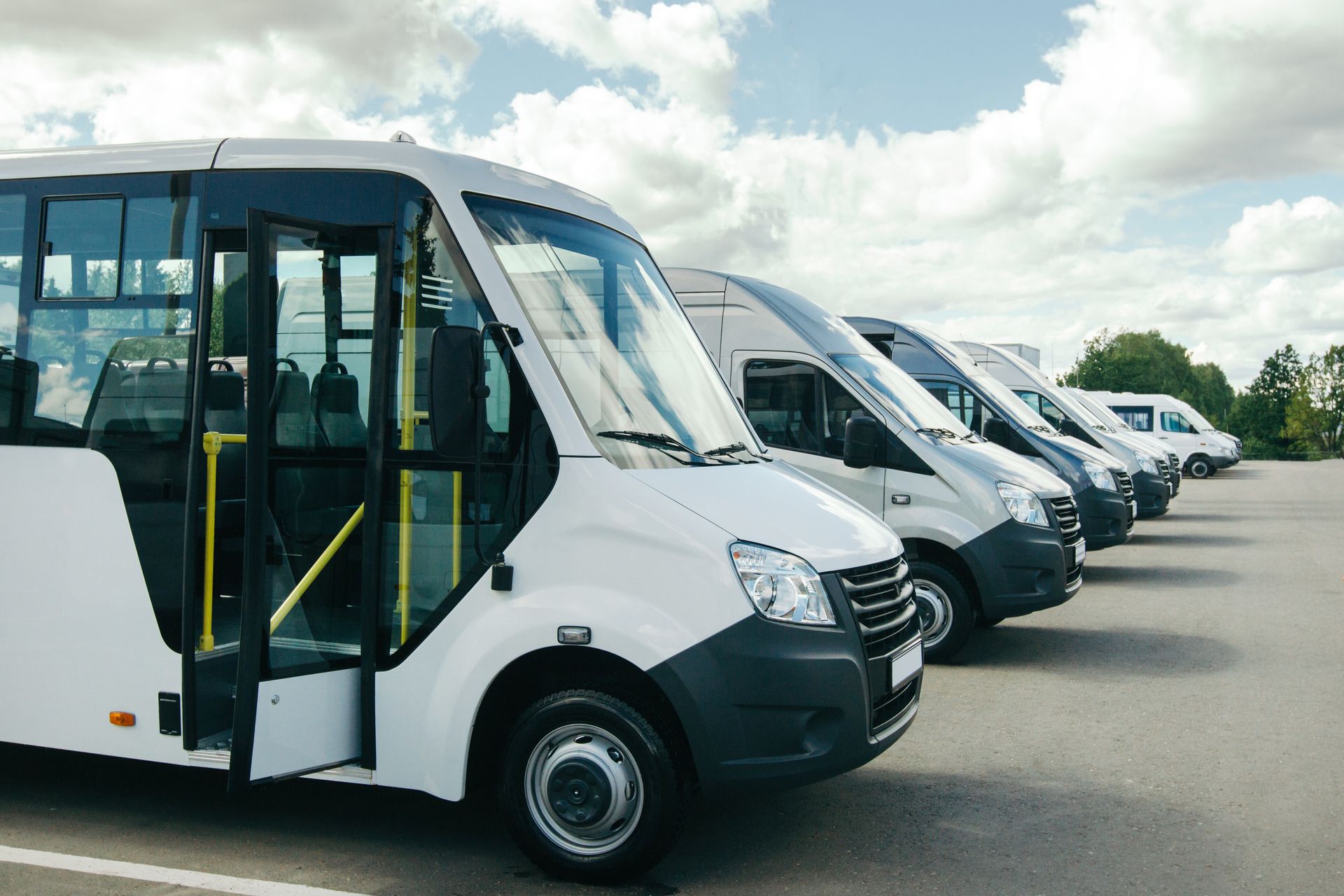 White Buses Parked in a Row — Dave's Drive U Anywhere 24/7 Mini Van Hire In Bulli, NSW