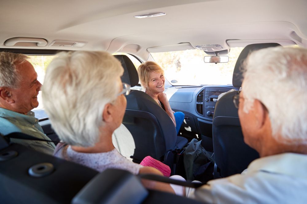 Four Older Adults in a Car — Dave's Drive U Anywhere 24/7 Mini Van Hire In Wollongong, NSW