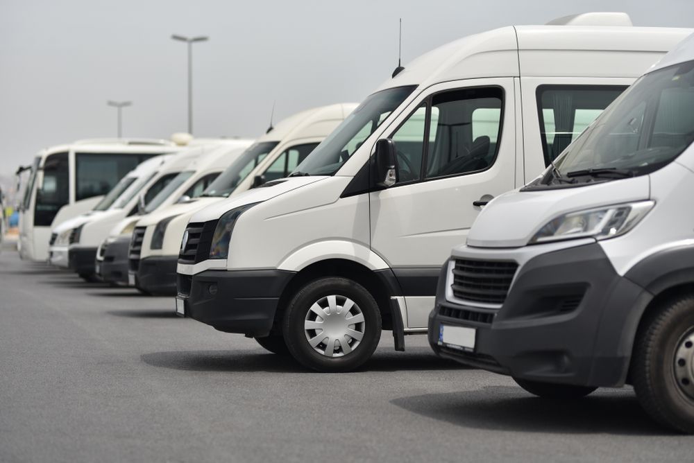 Line of White Vans Parked — Dave's Drive U Anywhere 24/7 Mini Van Hire In Austinmer, NSW