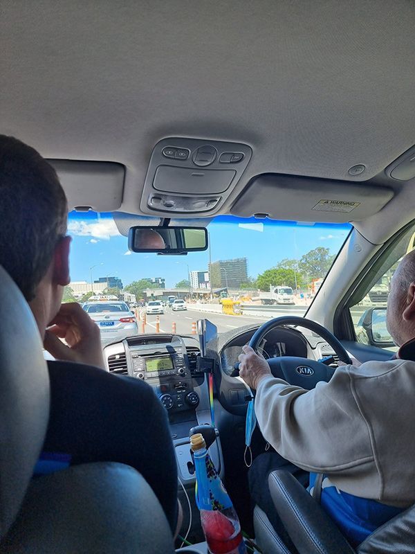 Two people with the driver focused on the road — Dave's Drive U Anywhere 24/7 Mini Van Hire In Wollongong, NSW